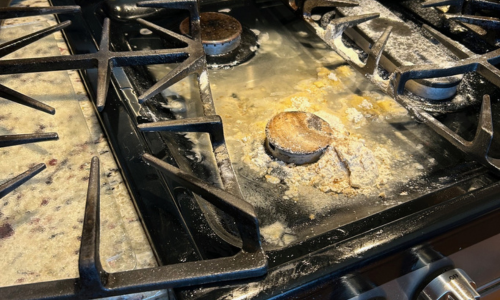 homestead kitchen fire safety—stovetop covered in baking soda after a grease fire accident
