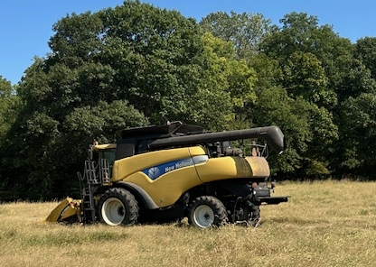 Family corn harvest with New Holland combine on a fall afternoon